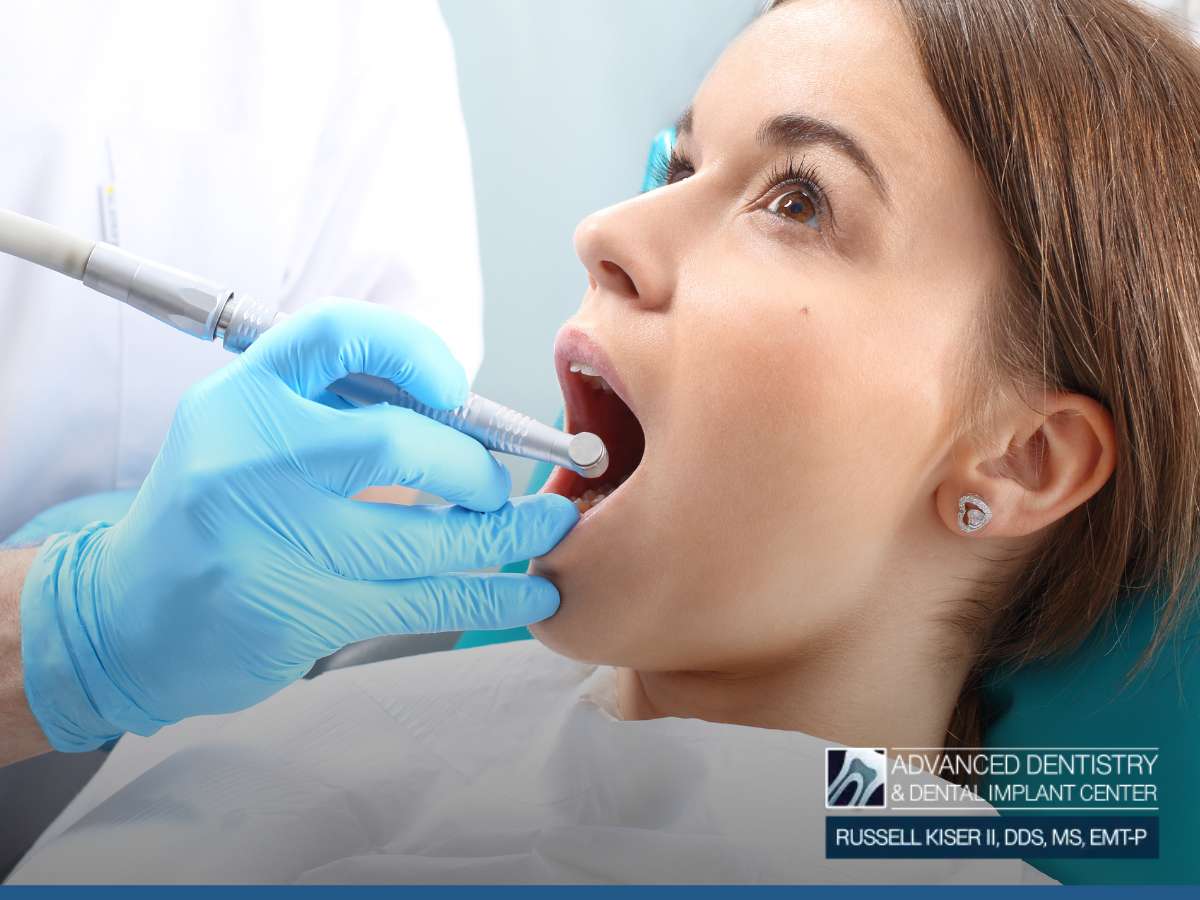 Woman undergoing a dental examination, potentially for root canal therapy, at Advanced Dentistry & Dental Implant Center.
