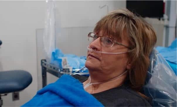 Patient receiving dental treatment with oxygen support in a dental clinic