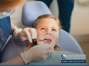 young girl receiving a Check-Up by a Children Dentist at Advanced Dentistry & Dental Implant Center with Dr. Russell Kiser