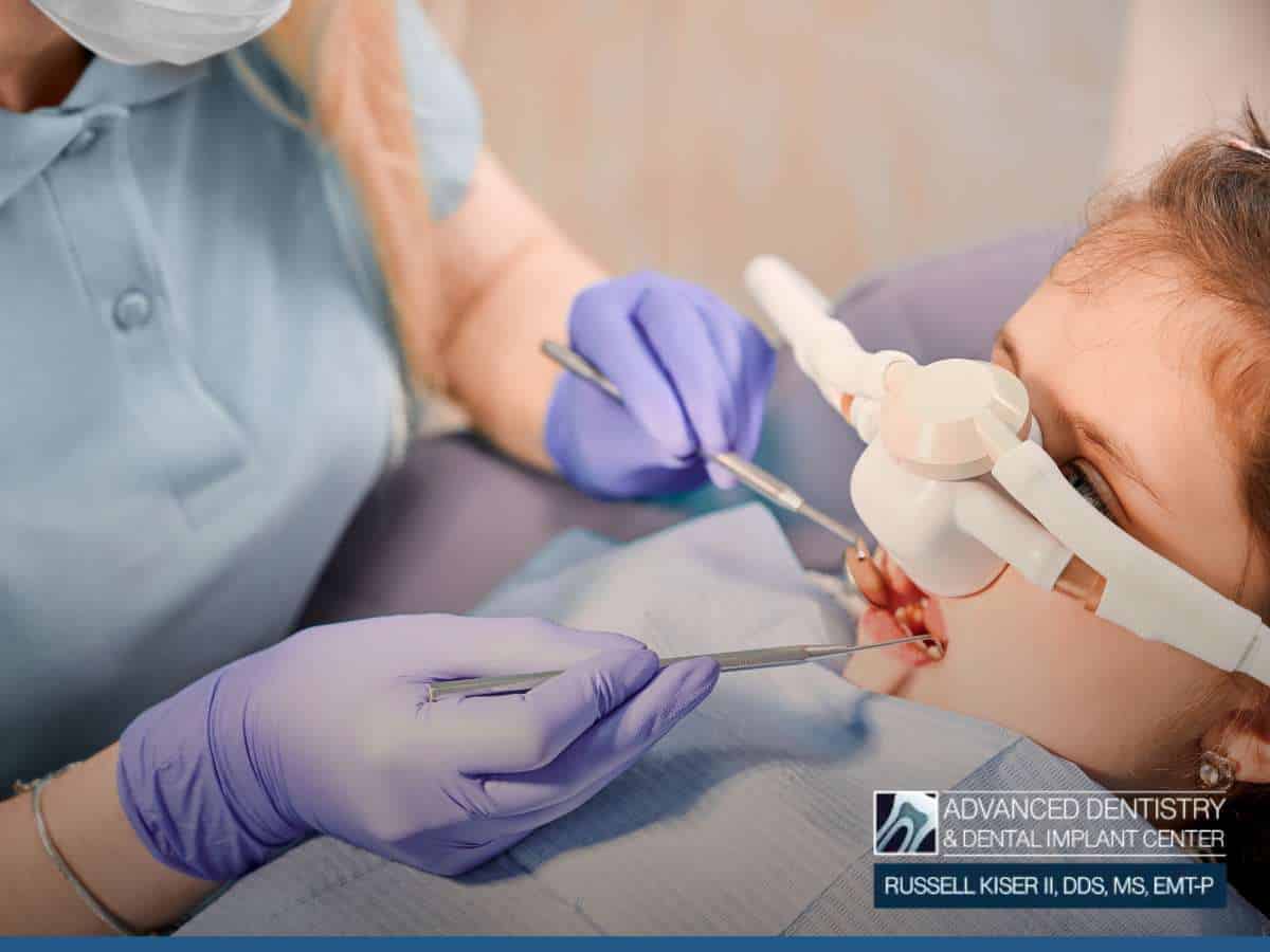 Dentist performing a procedure on a child under pediatric IV sedation for a stress-free experience